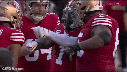 A Group Of Football Players Wearing Red Jerseys With The Number 5 On The Front GIF