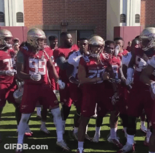 A Group Of Football Players Wearing Red Uniforms With The Number 29 On Them GIF
