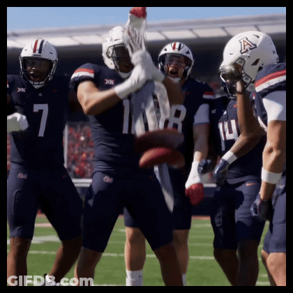 A Group Of Football Players With One Wearing A Helmet That Says A GIF