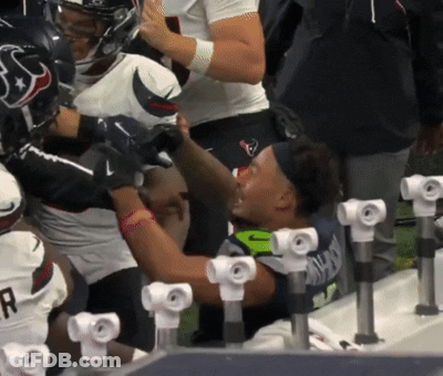 A Group Of Football Players With One Wearing A Helmet With The Letter H On It GIF