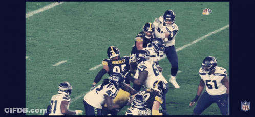 A Group Of Football Players With One Wearing The Number 51 On Their Jersey GIF