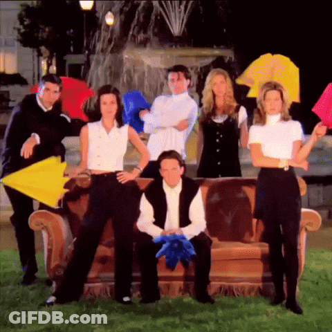 A Group Of Friends Posing For A Picture With Umbrellas In Front Of A Fountain GIF