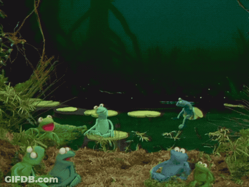 A Group Of Frogs Are Dancing In A Pond With A Frog In The Middle GIF