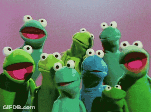 A Group Of Frogs With Big Eyes Are Standing Together GIF