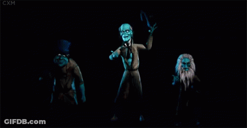 A Group Of Ghosts Are Dancing In The Dark . GIF
