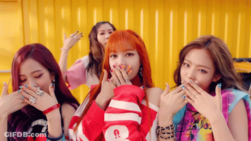 A Group Of Girls Are Covering Their Mouths With Their Hands And One Has A Shirt That Says Supreme On It GIF
