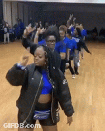 A Group Of Girls Are Dancing In A Gym . GIF