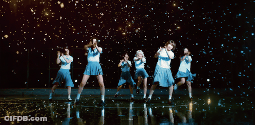 A Group Of Girls Are Dancing In Front Of A Black Background GIF