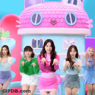 A Group Of Girls Are Dancing In Front Of A Pink Doll House GIF