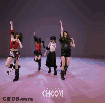 A Group Of Girls Are Dancing In Front Of A Studio Choom Sign GIF
