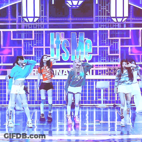 A Group Of Girls Are Dancing On A Stage In Front Of A Sign That Says ' It 'S Me ' GIF