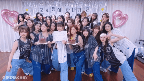 A Group Of Girls Are Posing For A Picture With A Sign That Says 24 GIF