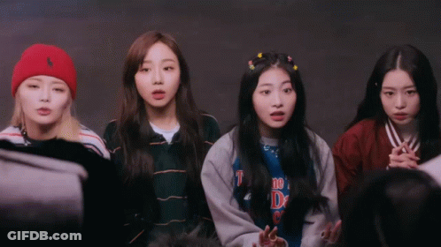 A Group Of Girls Are Standing In A Circle And One Of Them Is Wearing A Shirt That Says ' The D ' On It GIF