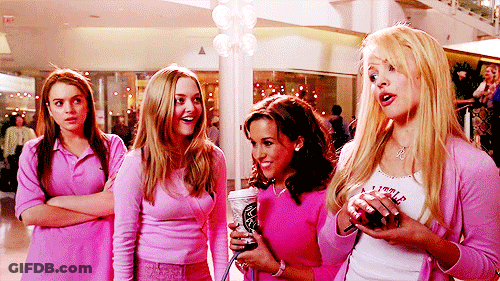 A Group Of Girls Are Standing In A Mall Wearing Pink GIF