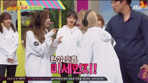 A Group Of Girls Are Standing Next To Each Other And One Of Them Is Wearing Headphones And Says ' Twice ' GIF