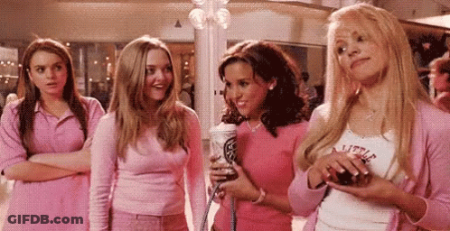 A Group Of Girls Are Standing Next To Each Other In A Shopping Mall . GIF