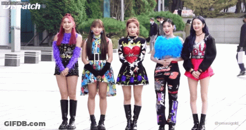 A Group Of Girls Are Standing Next To Each Other In Front Of A Building With Dispatch Written On The Bottom GIF
