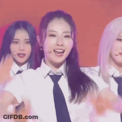 A Group Of Girls Are Standing Next To Each Other On A Stage . GIF