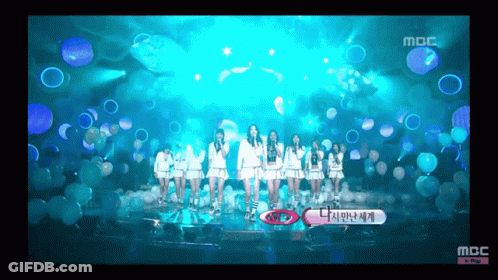 A Group Of Girls Are Standing On A Stage With Bubbles In The Background And The Words Mbc At The Bottom GIF