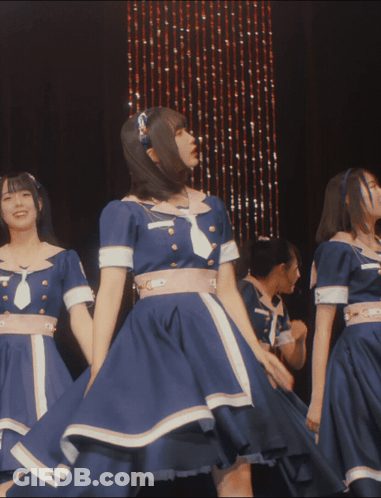 A Group Of Girls In Blue Dresses Are Dancing On Stage GIF