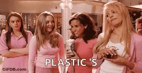 A Group Of Girls In Pink Clothes Are Standing Next To Each Other In A Mall And Talking To Each Other . GIF