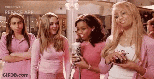 A Group Of Girls In Pink Outfits Are Standing Next To Each Other In A Mall . GIF