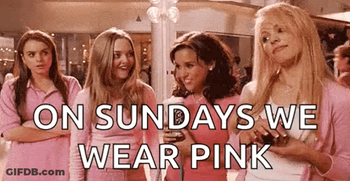 A Group Of Girls In Pink Shirts Are Standing Next To Each Other In A Room . GIF