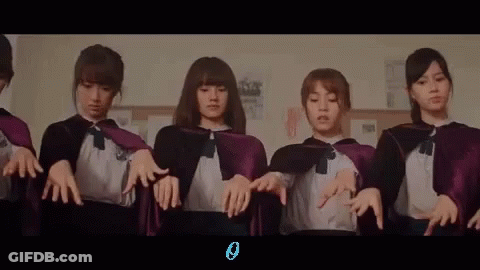 A Group Of Girls Wearing Purple Capes Are Standing Next To Each Other In A Room . GIF
