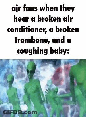 A Group Of Green Aliens Are Standing Next To Each Other In A Room . GIF
