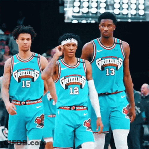 A Group Of Grizzlies Basketball Players Are Standing On The Court GIF