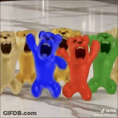 A Group Of Gummy Bears With Their Mouths Open Are Standing Next To Each Other . GIF