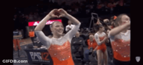 A Group Of Gymnasts Are Making A Heart With Their Hands . GIF