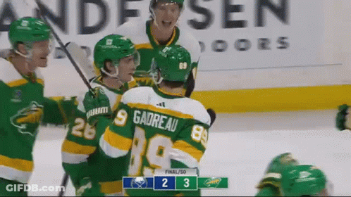 A Group Of Hockey Players Are Celebrating A Goal In Front Of A Scoreboard That Says 2 3 GIF