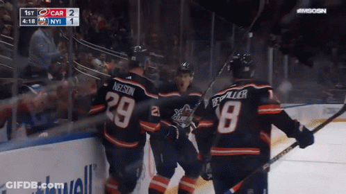 A Group Of Hockey Players Are Celebrating A Goal With The Number 29 On Their Jersey GIF