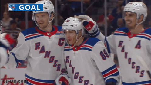 A Group Of Hockey Players Are Celebrating A Goal With The Word Goal Above Them GIF