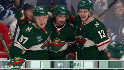 A Group Of Hockey Players Are Celebrating A Win And One Of Them Has The Number 13 On His Shirt GIF