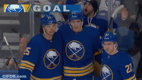 A Group Of Hockey Players Are Standing In Front Of A Goal Banner GIF