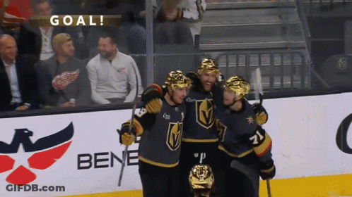 A Group Of Hockey Players Celebrate A Goal In Front Of A Bene Advertisement GIF