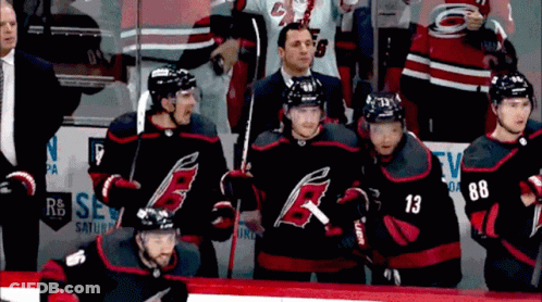 A Group Of Hockey Players Including Number 13 And 88 Are Standing On The Ice GIF