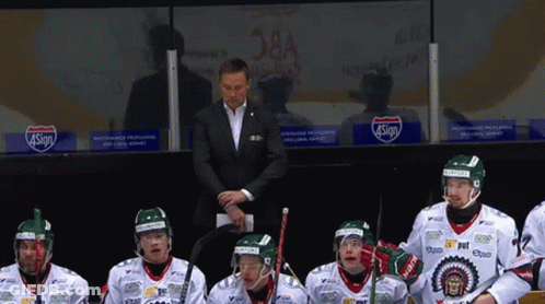 A Group Of Hockey Players Sitting In A Locker Room With A Sign That Says 4Sign On It GIF