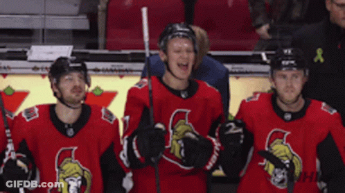 A Group Of Hockey Players Wearing Red And Black Jerseys GIF