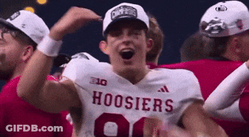 A Group Of Hoosier Football Players Are Celebrating A Win . GIF