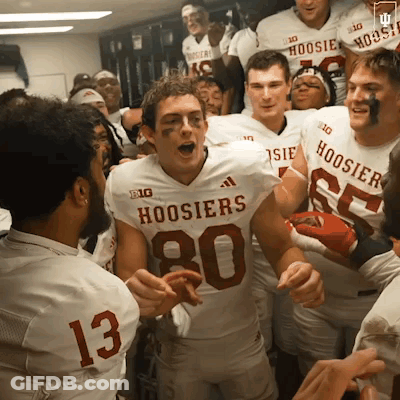 A Group Of Hoosier Football Players Are In A Locker Room GIF