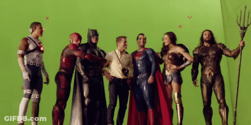 A Group Of Justice League Characters Are Posing For A Picture On A Green Screen GIF