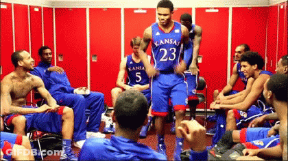 A Group Of Kansas Basketball Players Sitting In A Locker Room GIF