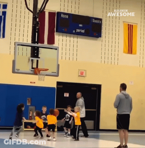 A Group Of Kids Are Playing Basketball In Front Of A Scoreboard That Says Home 1 Guests Period GIF