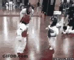 A Group Of Kids Are Practicing Martial Arts In A Gym GIF