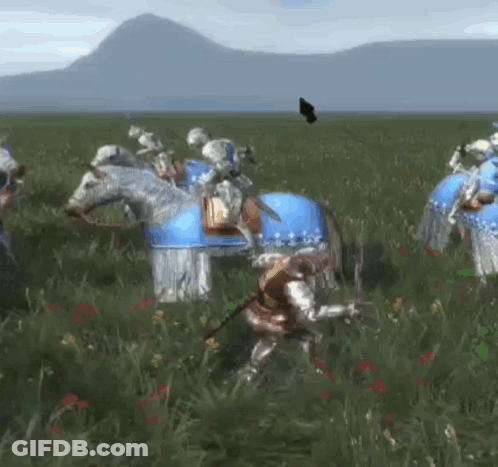A Group Of Knights Are Riding Horses In A Field With Mountains In The Background . GIF