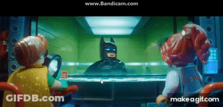 A Group Of Lego Characters Are Looking At Batman Through A Glass GIF