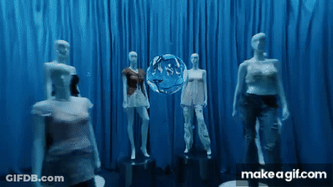 A Group Of Mannequins Are Standing In Front Of A Blue Curtain With A Make A Gif.com Logo GIF